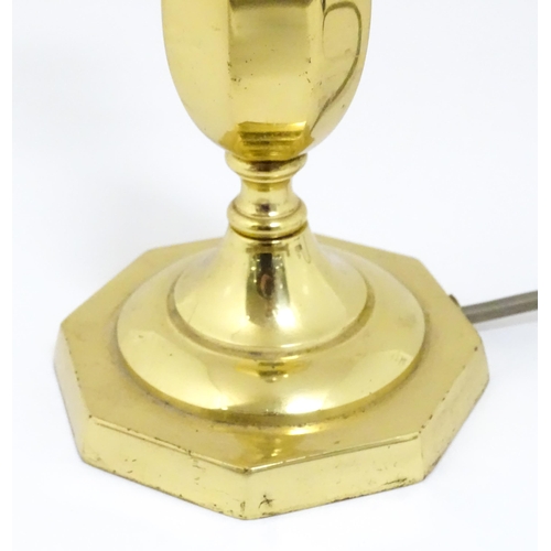 40 - A 20thC brass table lamp raised on an octagonal base. Approx. 12 1/2