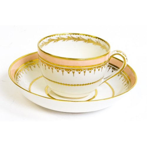 49 - A Derby tea cup and saucer with gilt detail. Bearing hand painted marks under. Cup approx. 2 1/4
