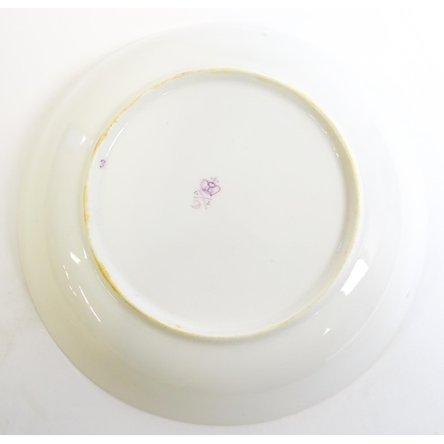 49 - A Derby tea cup and saucer with gilt detail. Bearing hand painted marks under. Cup approx. 2 1/4