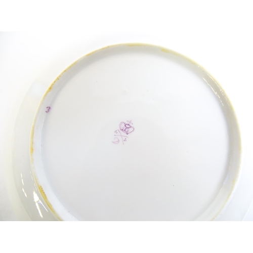 49 - A Derby tea cup and saucer with gilt detail. Bearing hand painted marks under. Cup approx. 2 1/4