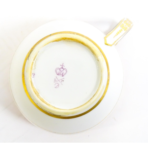 49 - A Derby tea cup and saucer with gilt detail. Bearing hand painted marks under. Cup approx. 2 1/4