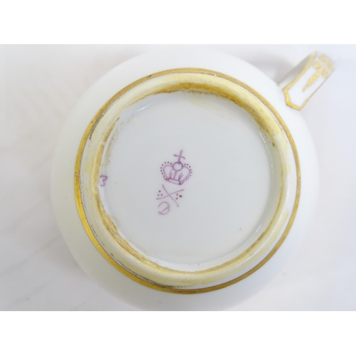 49 - A Derby tea cup and saucer with gilt detail. Bearing hand painted marks under. Cup approx. 2 1/4