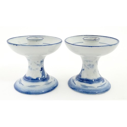 50 - A pair of Dutch blue and white candle holders of pedestal form with boat decoration. Approx. 4