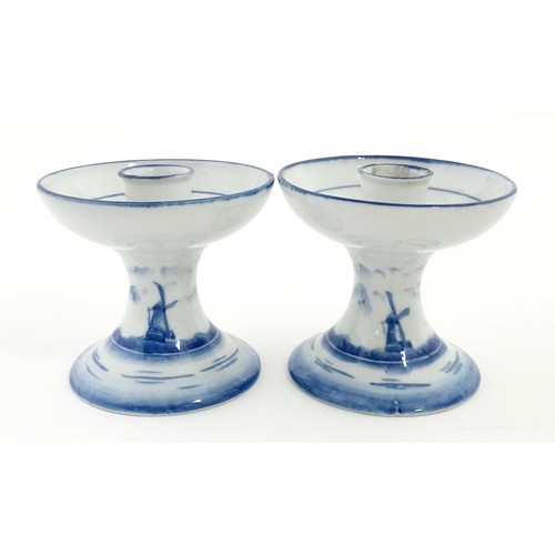 50 - A pair of Dutch blue and white candle holders of pedestal form with boat decoration. Approx. 4