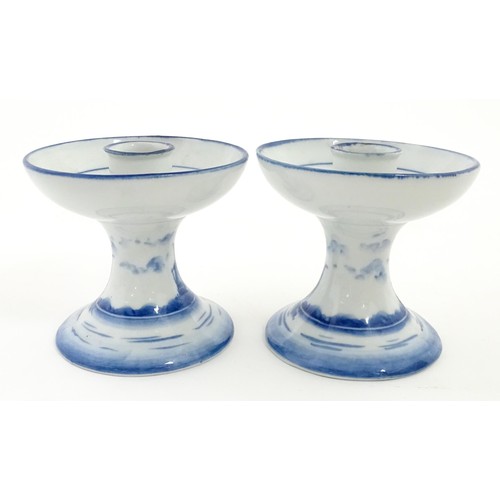 50 - A pair of Dutch blue and white candle holders of pedestal form with boat decoration. Approx. 4