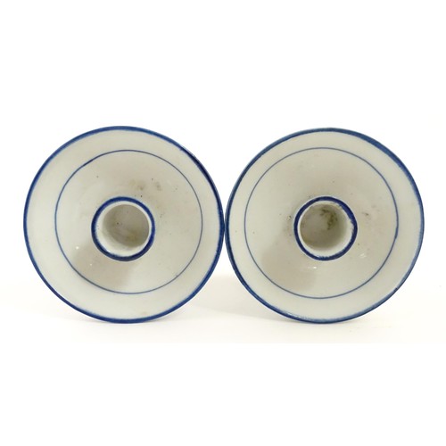 50 - A pair of Dutch blue and white candle holders of pedestal form with boat decoration. Approx. 4