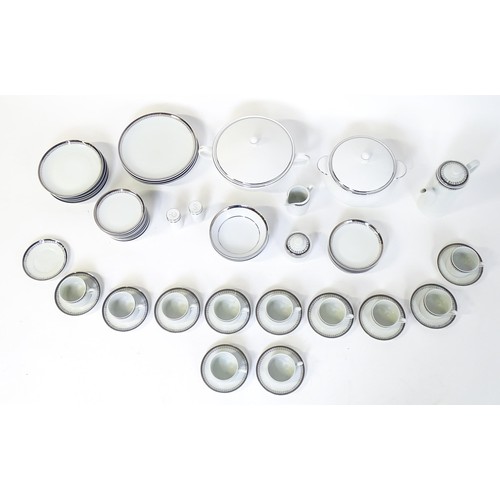 53 - A quantity of assorted dinner wares to include plates, tureens, coffee pot, cups, saucers, bowls, et... 