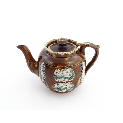 58 - Three items of Victorian Measham bargeware comprising a teapot decorated with birds and flowers with... 