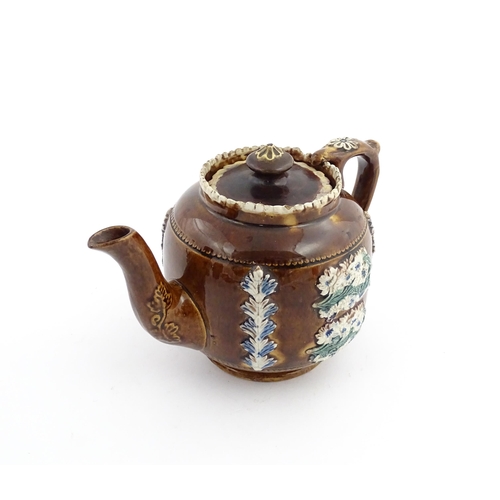 58 - Three items of Victorian Measham bargeware comprising a teapot decorated with birds and flowers with... 