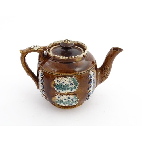 58 - Three items of Victorian Measham bargeware comprising a teapot decorated with birds and flowers with... 