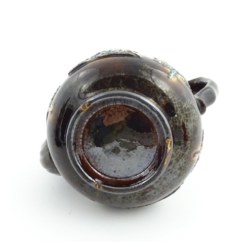 58 - Three items of Victorian Measham bargeware comprising a teapot decorated with birds and flowers with... 