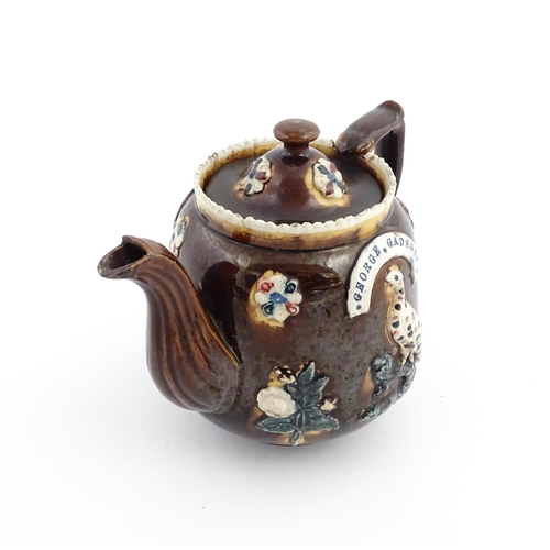 58 - Three items of Victorian Measham bargeware comprising a teapot decorated with birds and flowers with... 