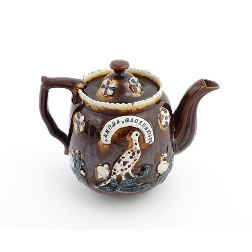 58 - Three items of Victorian Measham bargeware comprising a teapot decorated with birds and flowers with... 