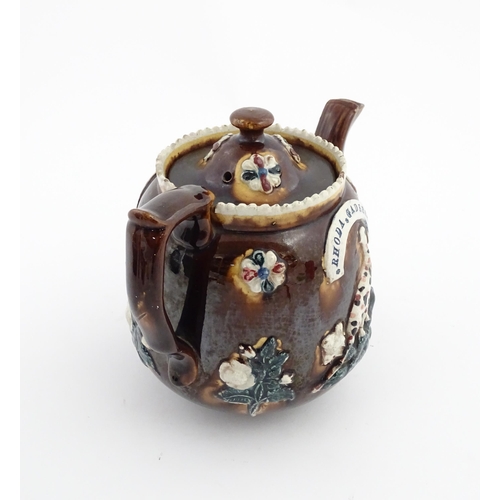 58 - Three items of Victorian Measham bargeware comprising a teapot decorated with birds and flowers with... 