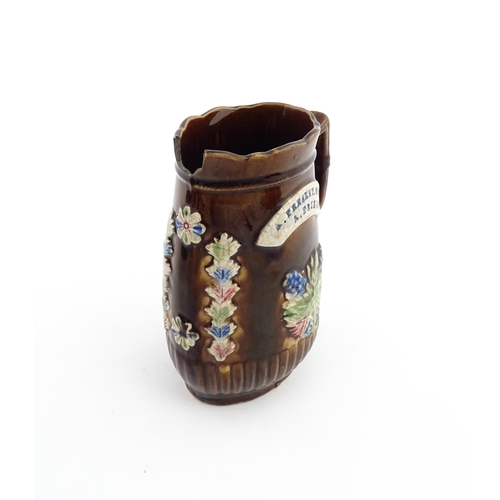 58 - Three items of Victorian Measham bargeware comprising a teapot decorated with birds and flowers with... 