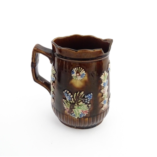 58 - Three items of Victorian Measham bargeware comprising a teapot decorated with birds and flowers with... 