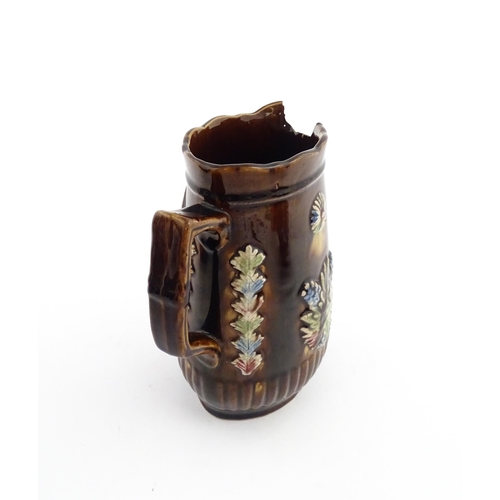 58 - Three items of Victorian Measham bargeware comprising a teapot decorated with birds and flowers with... 