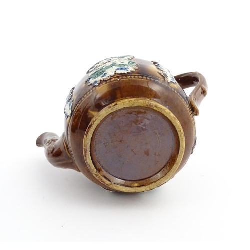 58 - Three items of Victorian Measham bargeware comprising a teapot decorated with birds and flowers with... 