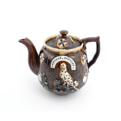 58 - Three items of Victorian Measham bargeware comprising a teapot decorated with birds and flowers with... 