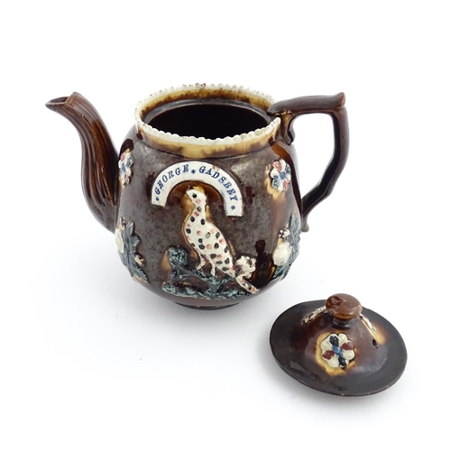 58 - Three items of Victorian Measham bargeware comprising a teapot decorated with birds and flowers with... 