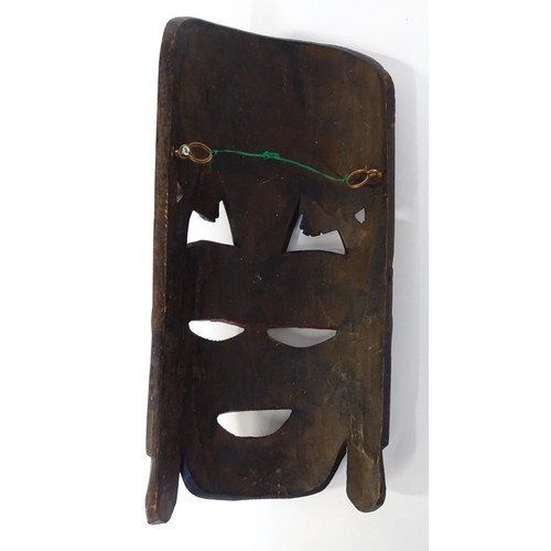 59 - Ethnographic / Native / Tribal : Three African carved masks with painted detail. Together with a car... 