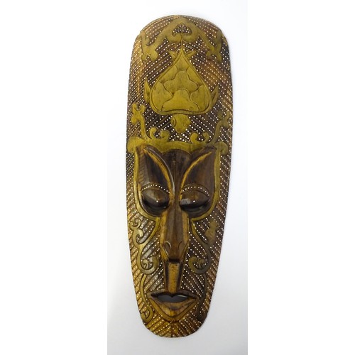 59 - Ethnographic / Native / Tribal : Three African carved masks with painted detail. Together with a car... 