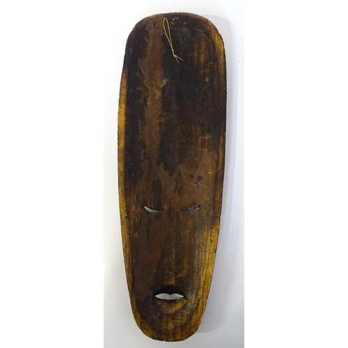 59 - Ethnographic / Native / Tribal : Three African carved masks with painted detail. Together with a car... 