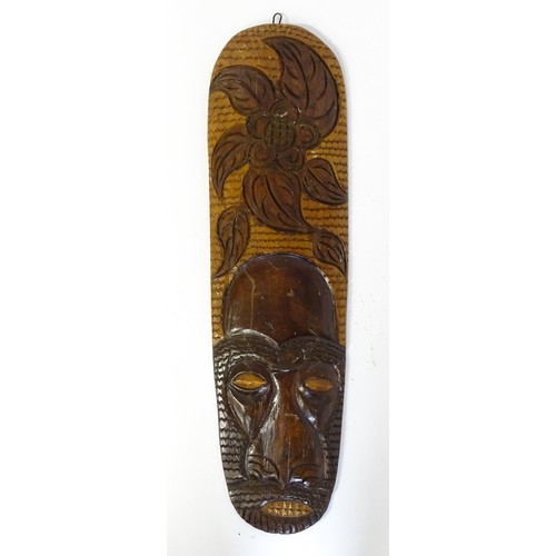 59 - Ethnographic / Native / Tribal : Three African carved masks with painted detail. Together with a car... 