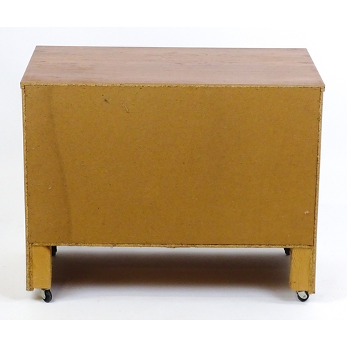 21 - Vintage / Retro: A teak two door cabinet raised on castors. 29 1/2