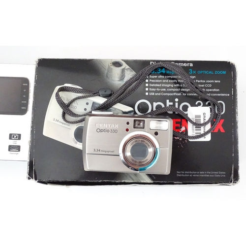29 - A quantity of assorted cameras to include a Pentax Optio 330, a Hirix HD dual lens dash cam, an Olym... 