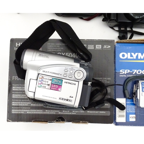 29 - A quantity of assorted cameras to include a Pentax Optio 330, a Hirix HD dual lens dash cam, an Olym... 