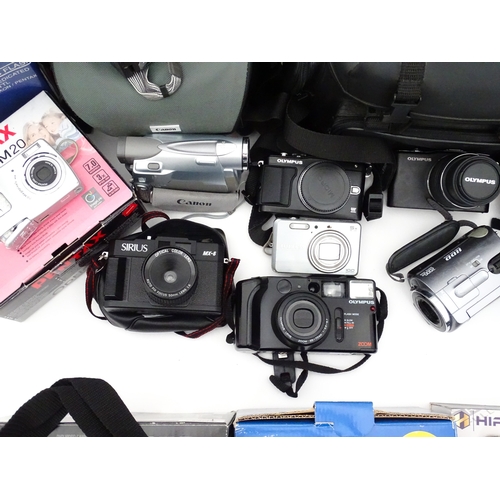 29 - A quantity of assorted cameras to include a Pentax Optio 330, a Hirix HD dual lens dash cam, an Olym... 