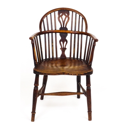 A 19thC double bow back Windsor chair with a pierced back splat above a shaped seat and raised on four turned tapering legs. 22" wide x 16" deep x 34" high.
