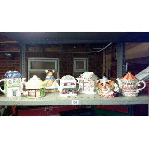 121 - A quantity of character teapots etc.