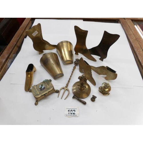 102 - A mixed lot of brass including stamp box, shoes etc