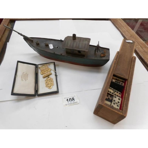 108 - A tin boat, Masonic medal and old dominoes