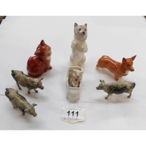 111 - A Royal Doulton dog, Beswick cat, dog in car and 3 lead cows