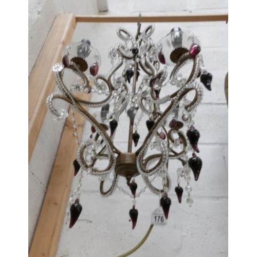 176 - A vintage 4 light metal and glass chandelier