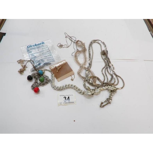 34 - A quantity of white metal necklaces etc