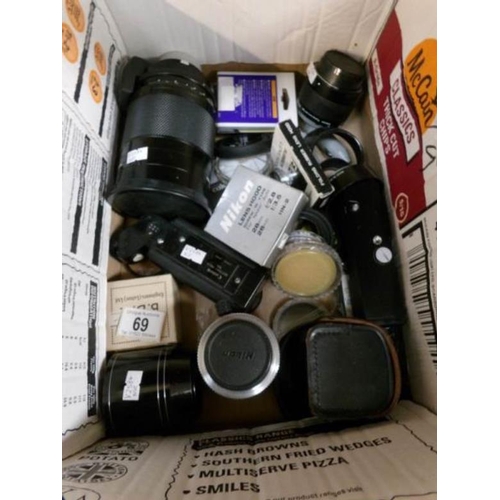 69 - A box of photographic equipment including Nikon 500mm mirror telelens, 2 motor drives etc.,