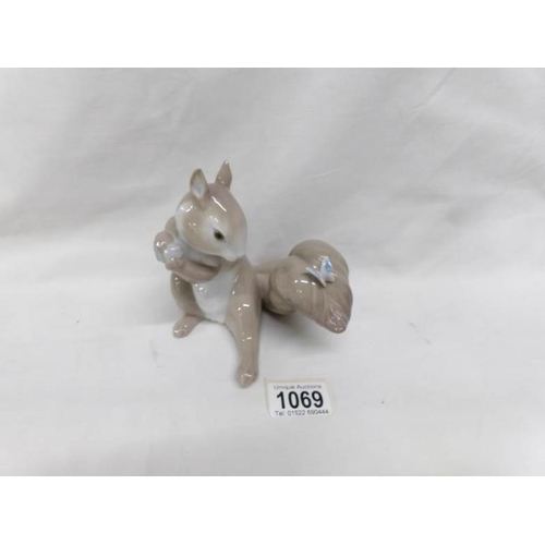 1069 - A Lladro figure of a squirrel with a butterfly on his tail