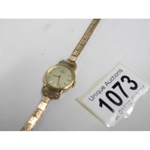 1073 - A 9ct gold ladies Seiko wristwatch on 9ct gold strap