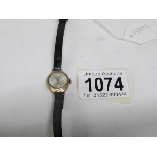 1074 - A 9ct gold Camy wristwatch on leather strap