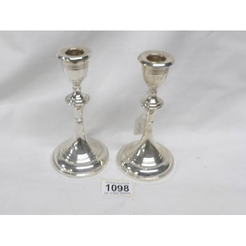 1098 - A pair of silver candlesticks