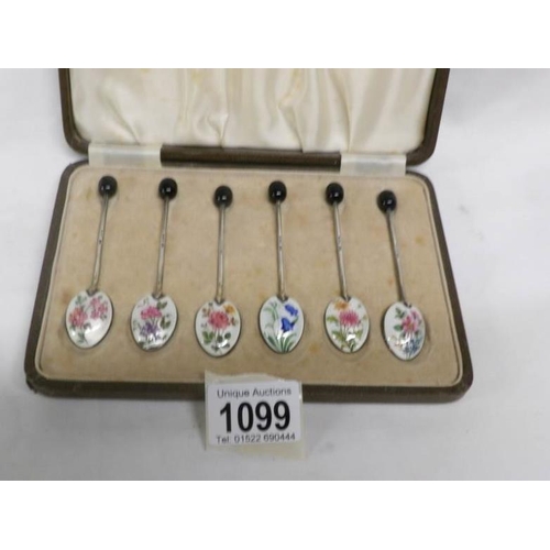 1099 - A cased set of 6 silver and enamel coffee spoons with floral decoration