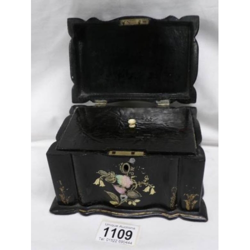 1109 - A lacquered tea caddy inlaid with mother of pearl