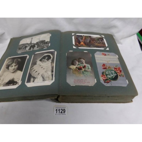 1129 - An album of approximately 325 postcards including 16 Mabel Lucie Attwell, Greetings etc