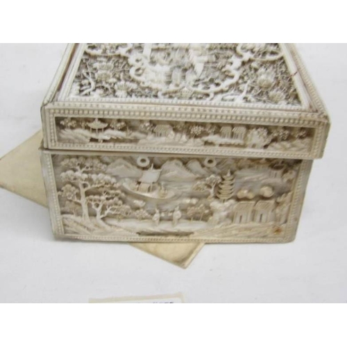 1192 - A heavily carved antique ivory box, carved on all sides and top, 11 x 14 x 7.5cm