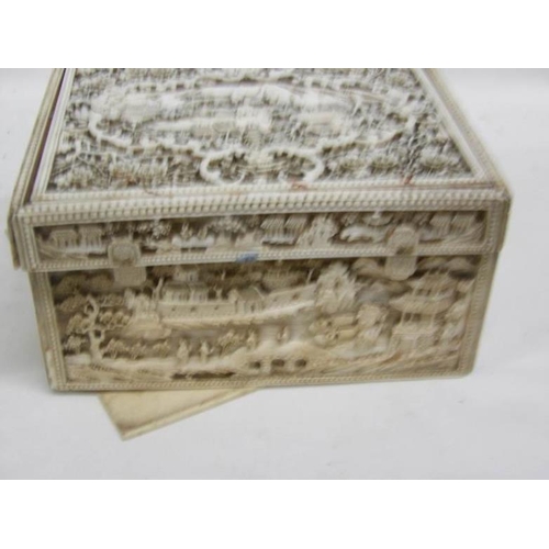 1192 - A heavily carved antique ivory box, carved on all sides and top, 11 x 14 x 7.5cm