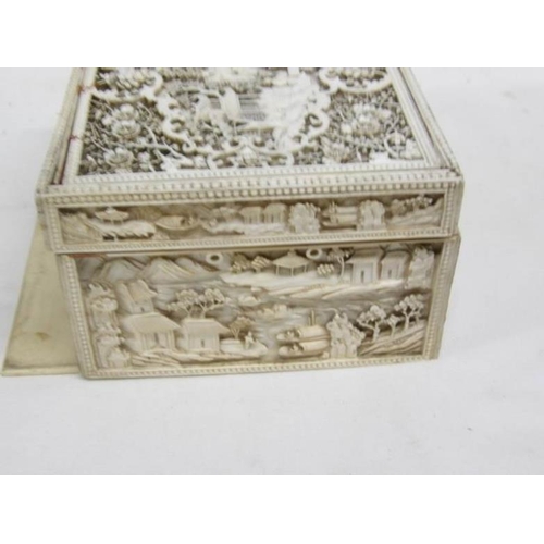 1192 - A heavily carved antique ivory box, carved on all sides and top, 11 x 14 x 7.5cm